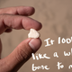 It's a photo of a white and pot-marked piece of plastic that looks like a bone. There's handwriting over the photo that reads: "It looked like a whale bone to me."